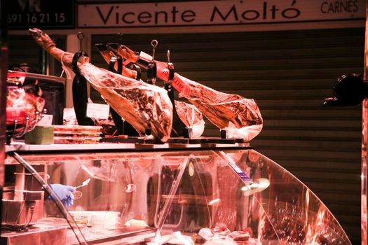 Elche, Alicante, Spain- March 28, 2022: Iberian Ham for sale at a market stall in the Central Market Alicante