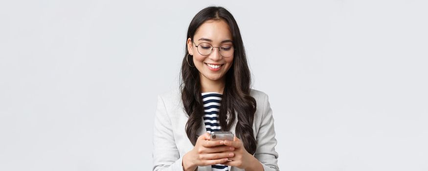 Business, finance and employment, female successful entrepreneurs concept. Attractive modern businesswoman messaging, using taxi app as head meeting with clients, white background.