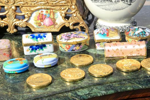 Guardamar, Alicante, Spain- April 3, 2022: Vintage pillboxes and antiques for sale at the flea market called El Fogon in Guardamar, Alicante