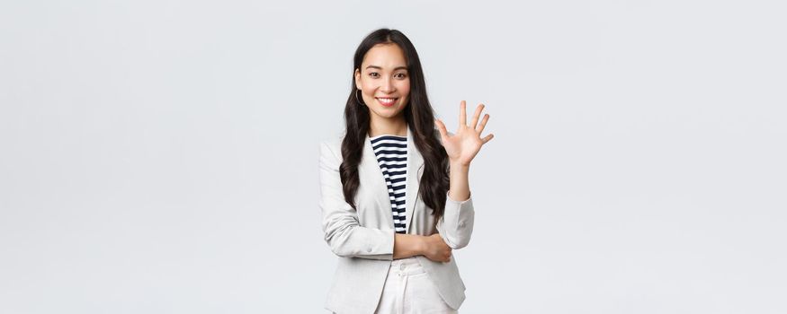 Business, finance and employment, female successful entrepreneurs concept. Successful female businesswoman, asian real estate broker pointing finger, showing number five and smiling.