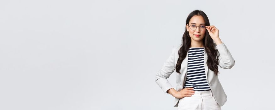 Business, finance and employment, female successful entrepreneurs concept. Confident businesswoman in glasses and white suit ready for meeting, smiling pleased, standing determined.
