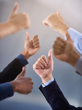 Cropped shot of a group of businesspeople showing a thumbs up gesture.