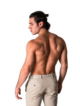 Three quarters shot of handsome shirtless athletic young man in pants, in studio shot, isolated on white background