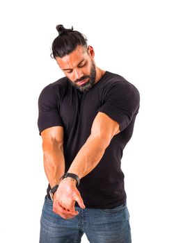 Handsome muscular man stretching arm and shoulder, isolated on white, wearing black t-shirt and jeans