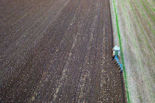 Agriculture. Agriculture. Tractor working in the field. Aerial view. Tractor plowed field. Copy space.