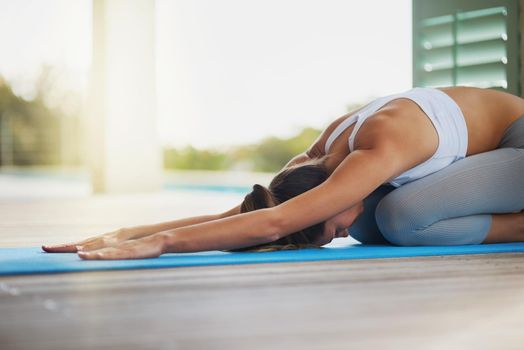 Shot of an attractive young woman working out at home.