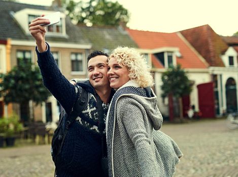 Cropped shot of a young couple taking selfies while on vacation.