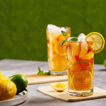 Iced tea. Traditional iced tea with lemon and ice in tall glasses.