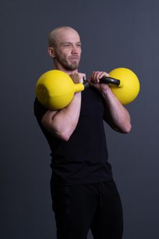 Guy with a yellow kettlebell gym anonymous workout male, for sporty effort in picking and floor youth, asian activity. Living interval cardio, building hiit