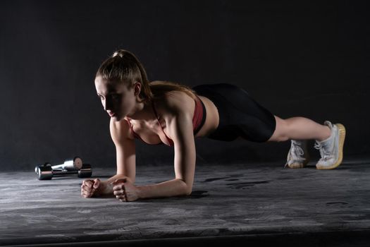 Girl plank with stands the the in a dumbbells on floor push-ups looks like a kira knightley girl fitness sports, for caucasian fit for woman for sport isolated, strength biceps. Slim care weight