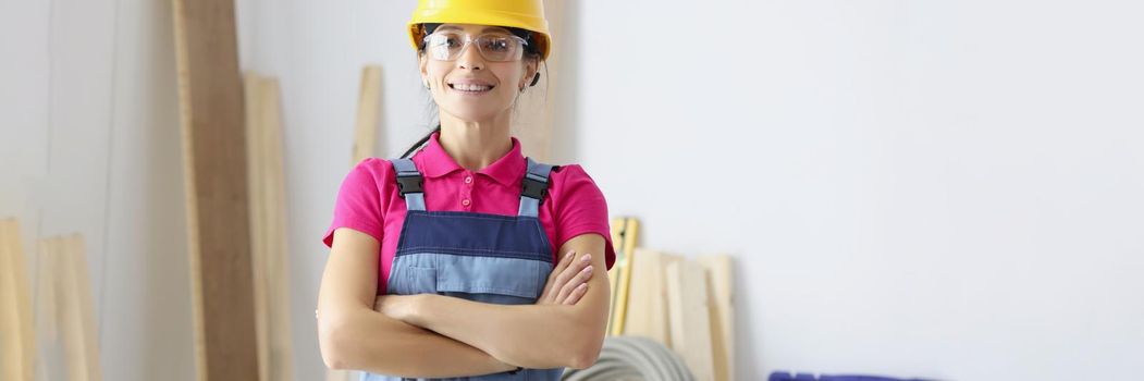 Portrait of woman forewoman at construction project, control progress at work, finish modern renovation in clients house. Tools for work, wooden planks. Renovation, handyman, boss concept