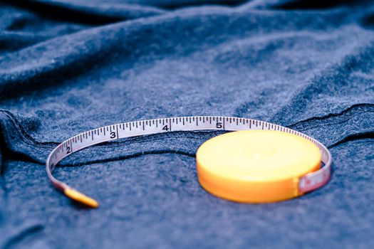 Measuring tape on the cotton cloth material with a blue color