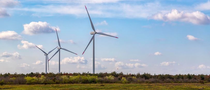 Panoramic view of a wind turbine farm the blue day sky