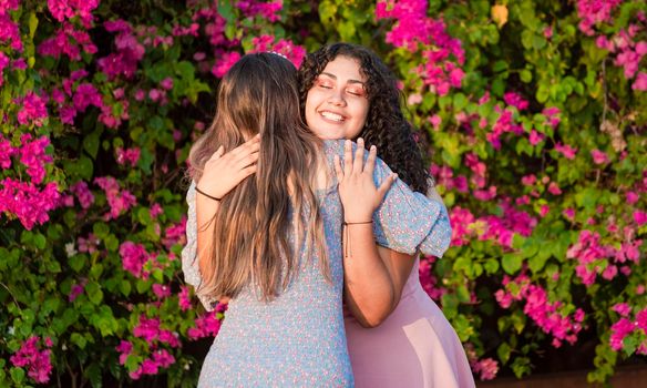 two women friends hugging, girl congratulating and hugging her friend, women's day concept