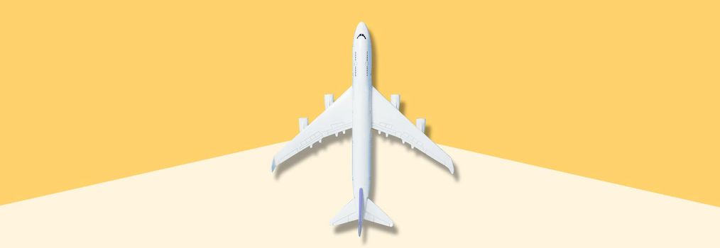 White airplane on blue background, top view, creative concept of air transportation, tourism, travel. Copy space for text. High quality photo