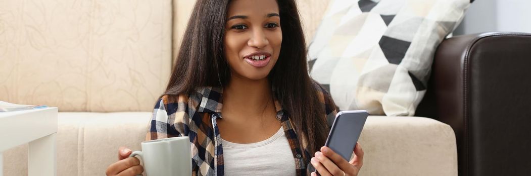 Portrait of woman surprised with end of movie, watching film online on website, open laptop on lap. Female record voice message to friend, hold smartphone in hand. Leisure, rest concept