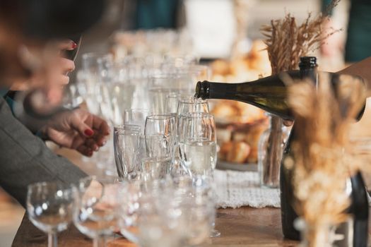 A waiter pours champagne at a wedding