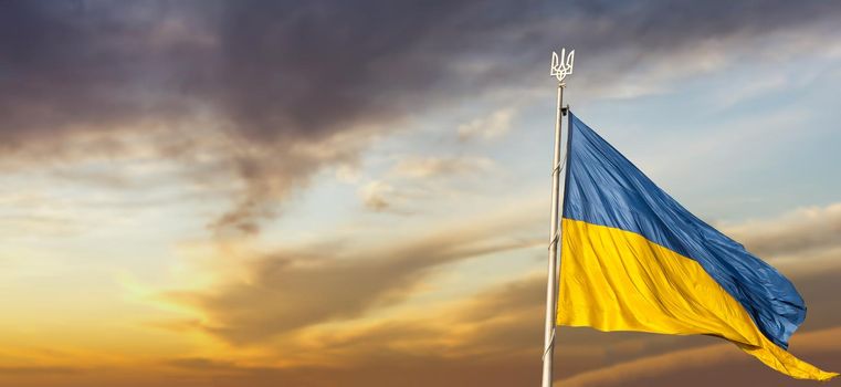 Flag of Ukraine against the backdrop of sunrise. Yellow-blue flag of independent Ukraine