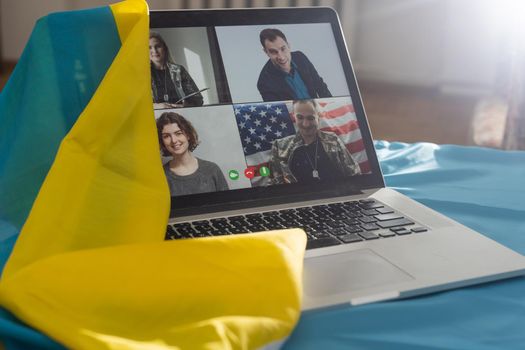 news about Ukraine on laptop. flag of ukraine background