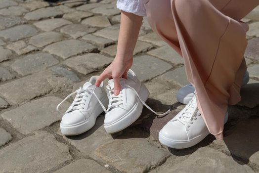 New and old white sneaker shoes . contrast, comparison, different, new and old, good and bad, clean and dirty concept. woman puts on new shoes