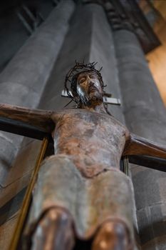 A statue of Jesus hanging on a cross in a church