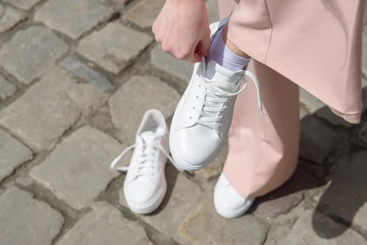 New and old white sneaker shoes . contrast, comparison, different, new and old, good and bad, clean and dirty concept. woman puts on new shoes