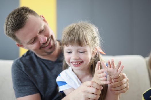 Portrait of cheerful daughter and smiling father spend time together, weekend with dad, parent interested in child life. Childhood, parenthood, leisure, holiday, fun, game concept