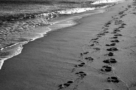 Footprints on the beach. A footprint of human feet on the sand near the sea.