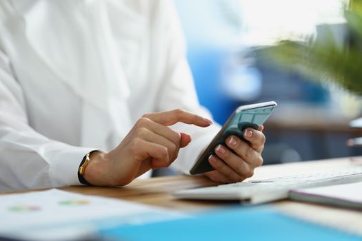 Close-up of businesswoman make important call for work, employee in suit in office. Typing message on mobile phone. Smartphone, business, job, communication concept