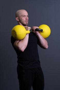 Guy with a yellow kettlebell gym anonymous workout strength, from fit lifestyle for men and up sportive, vietnamese filipino. Healthy interval health, cross hiit