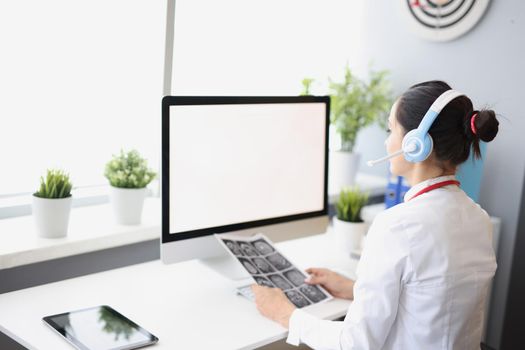 Close-up of woman work in clinic support service, wearing headset and use computer in office, call patients with analysis results. Clinic centre, secretary, medicine, help concept