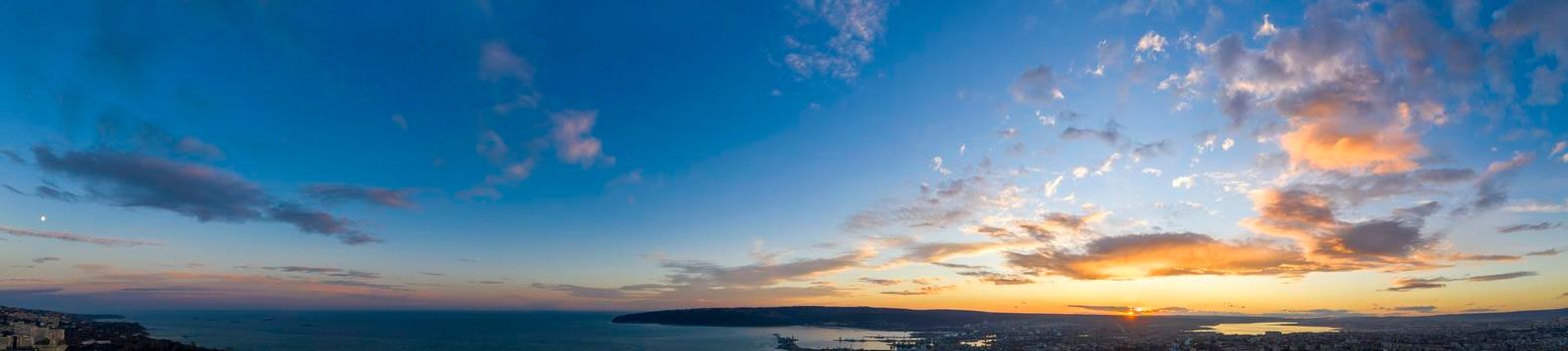 Panoramic view of the amazing sunset sky over the sea.