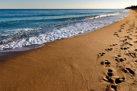 Footprints on the beach. A footprint of human feet on the sand near the sea.