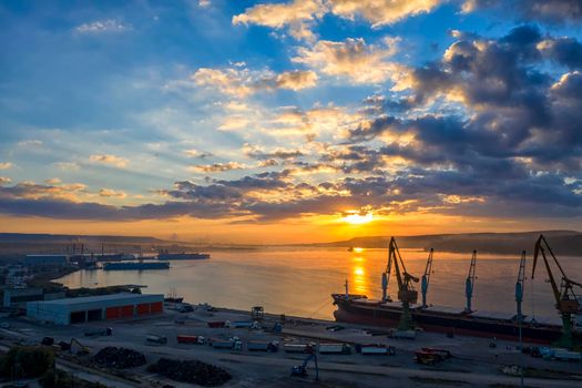 Amazing colorful sunrise over the sea. Aerial view from a port