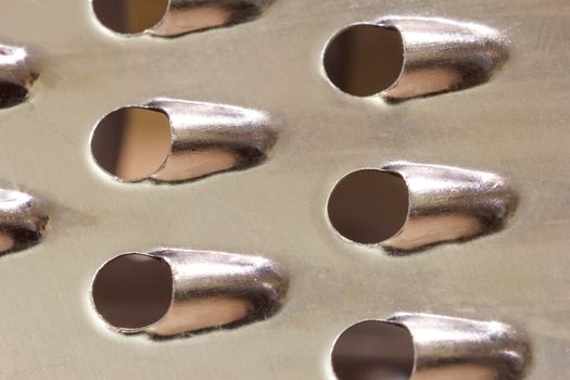 Vegetable slicer surface. Grater abstract close-up macro shot for background. 