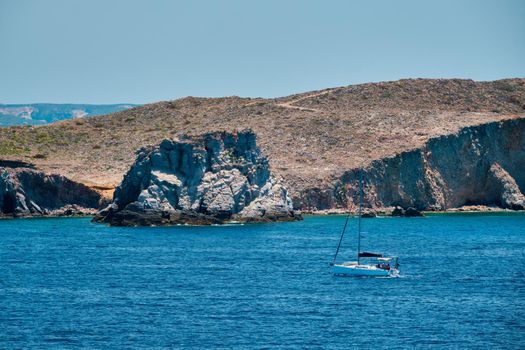 Yacht boat in blue waters of Aegean sea near Milos island , Greece