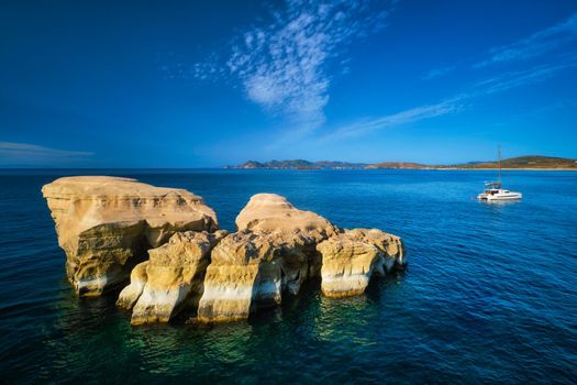 White rocks of famous tourist attraction of Milos island Sarakiniko beach and yacht boat at Sarakiniko Beach, Milos island , Greece