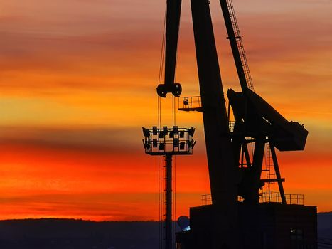 silhouette of the port crane at amazing red sunset