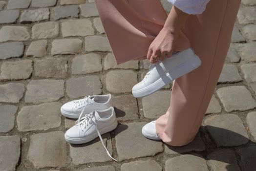 New and old white sneaker shoes . contrast, comparison, different, new and old, good and bad, clean and dirty concept. woman puts on new shoes