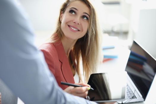 Portrait of smiling worker woman helping colleague with project. Blonde employee use laptop, friendly communication with team. Business, office life, occupation, career concept