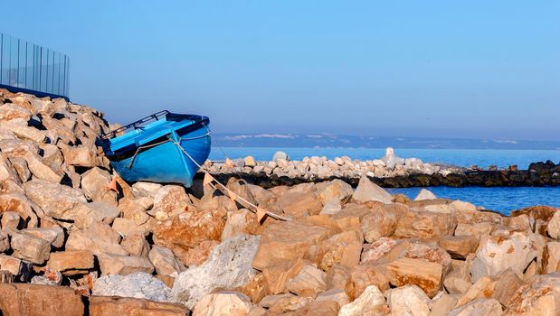 Parked Boat on the rocks on the beach