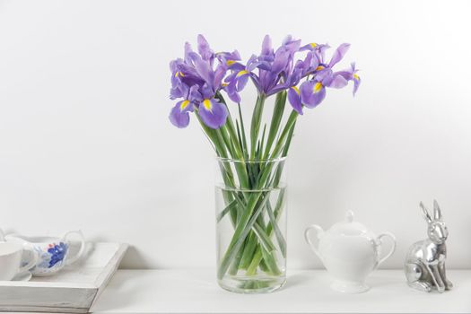 Violet Irises xiphium (Bulbous iris, sibirica) on white background with space for text. Top view, flat lay. Holiday greeting card for Valentine's Day, Woman's Day, Mother's Day, Easter!