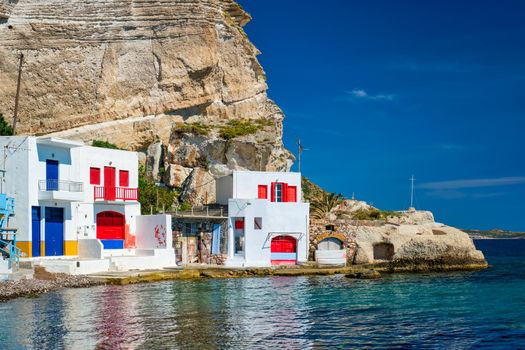 Scenic picturesque greek fishing village Klima with whitewashed traditional houses and colorful windows and doors on Milos island in Greece