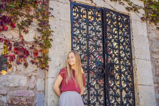 Woman tourist on background of beautiful view of the island of St. Stephen, Sveti Stefan on the Budva Riviera, Budva, Montenegro. Travel to Montenegro concept.