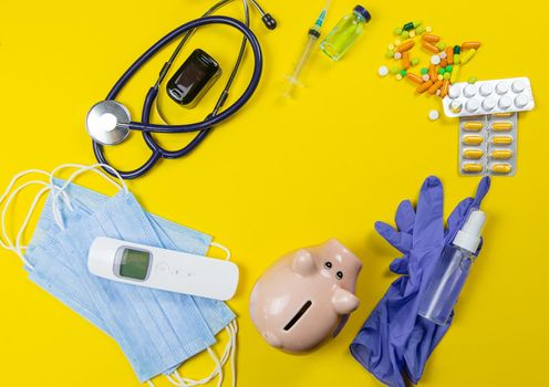 medical supplies on a yellow background, pills water treatment mask virus.