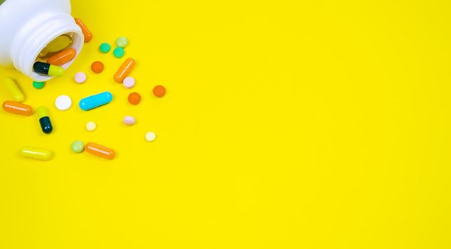 medicines, pills, mask, virus on a yellow background covid