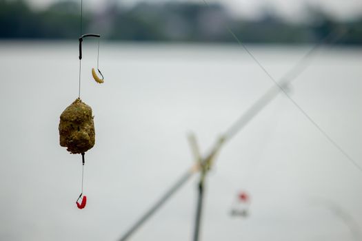 fishing tackle on a wooden float with mountain background and selective focus, nature