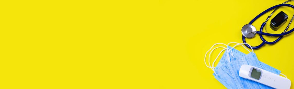 medicines, pills, mask, virus on a yellow background covid