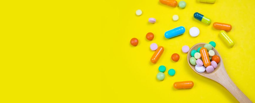 medicines, pills, mask, virus on a yellow background covid
