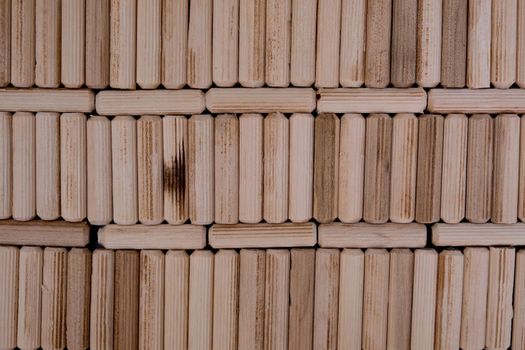 View of a grouping of wooden dowels as background. Close-up.